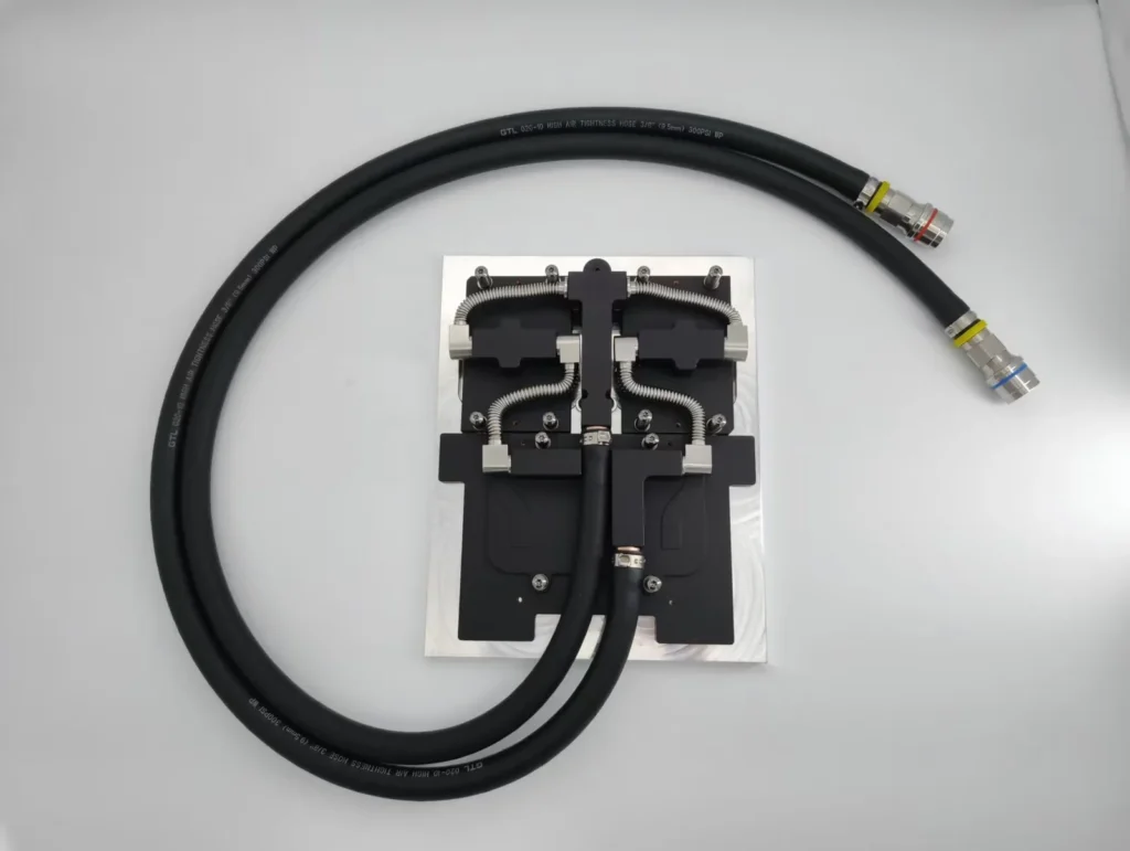 ToneCooling GB200 cold plate kit on a mounting plate with braided hoses and quick disconnect fittings